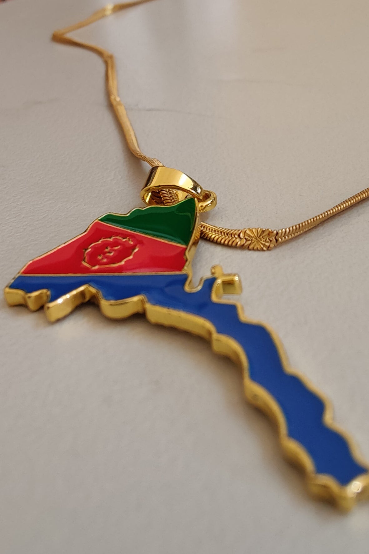 WELEBA Eritrean flag and map design necklace featuring vibrant colors and detailed craftsmanship on a sleek chain.